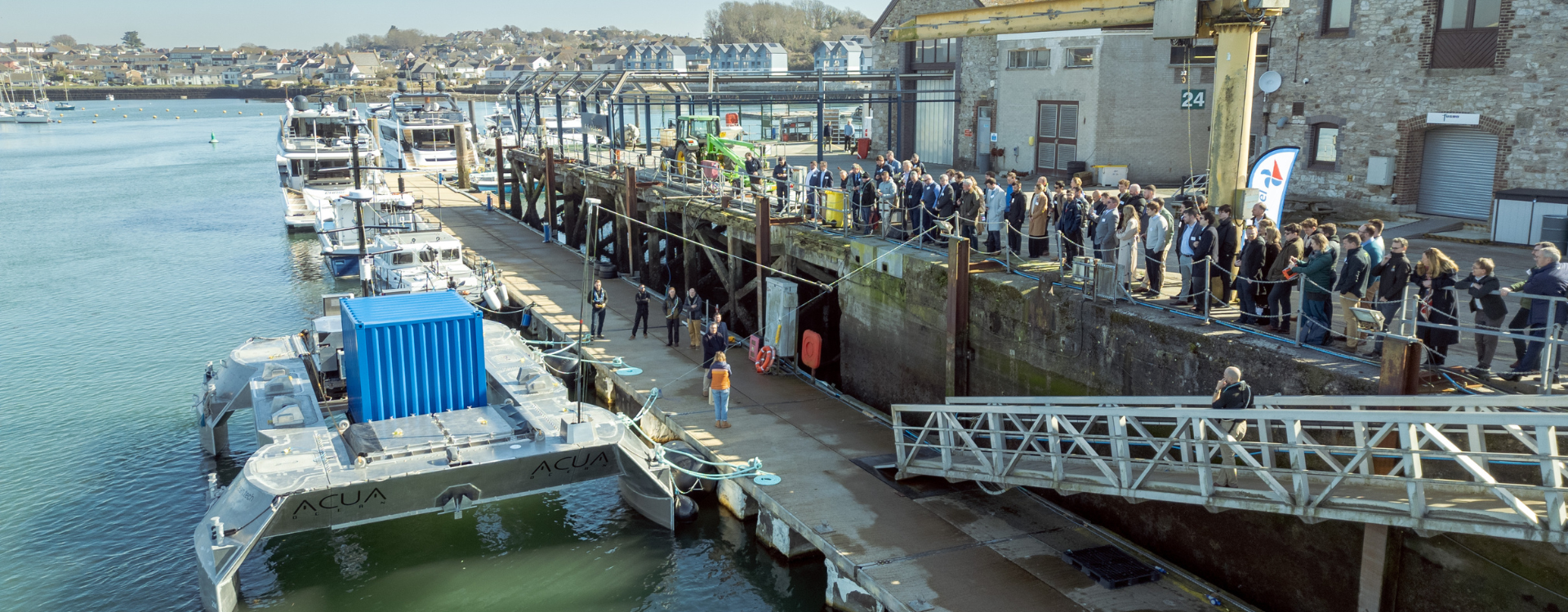 People waiting on the dock for the boat to go in the sea