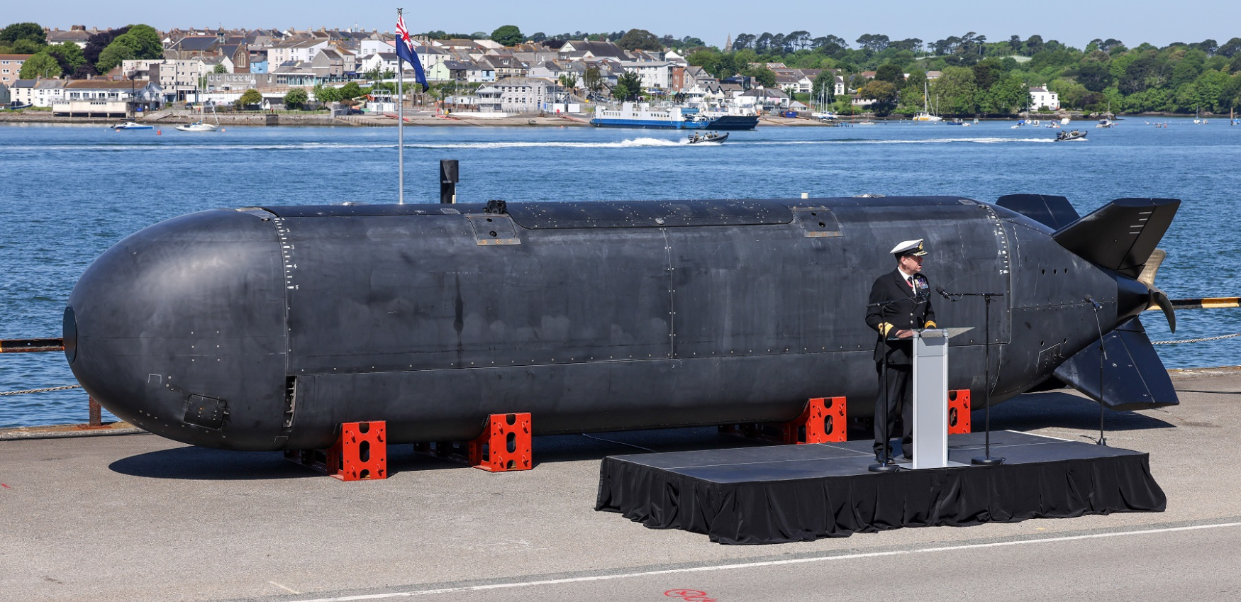 A person stood infront of a Submarine 