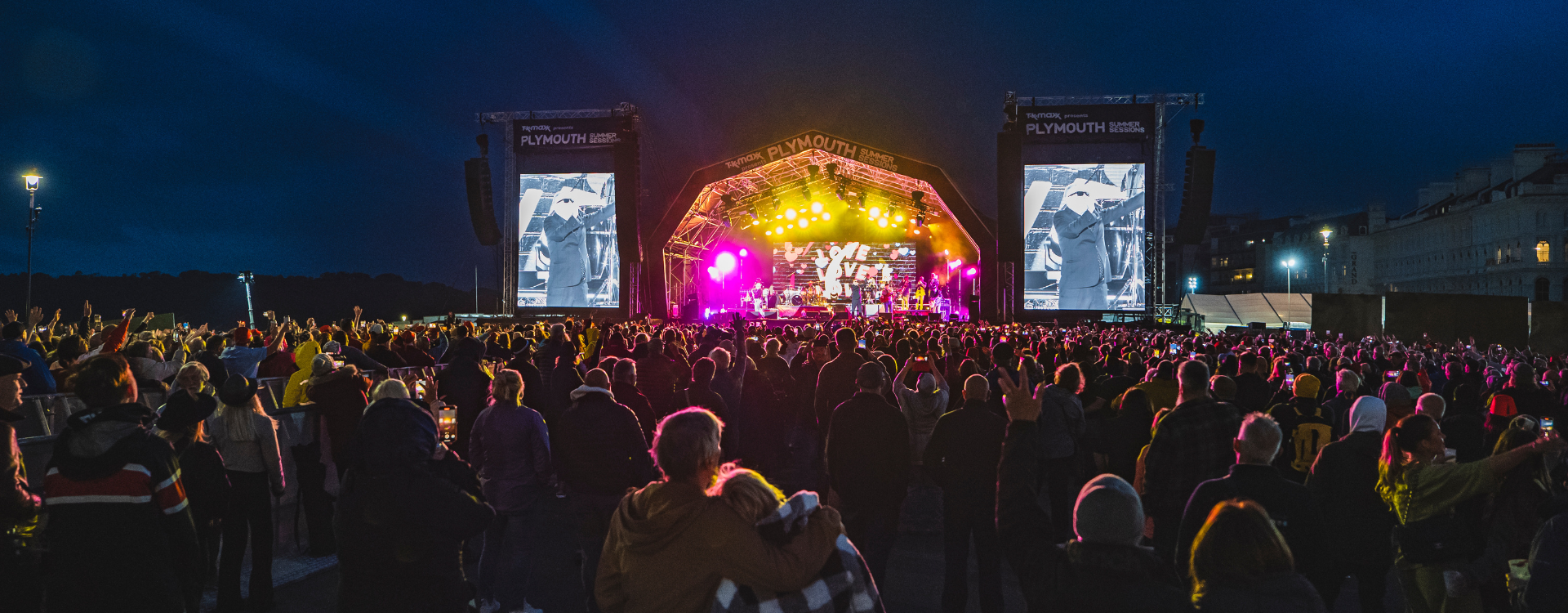 People watching music at a concert at night 