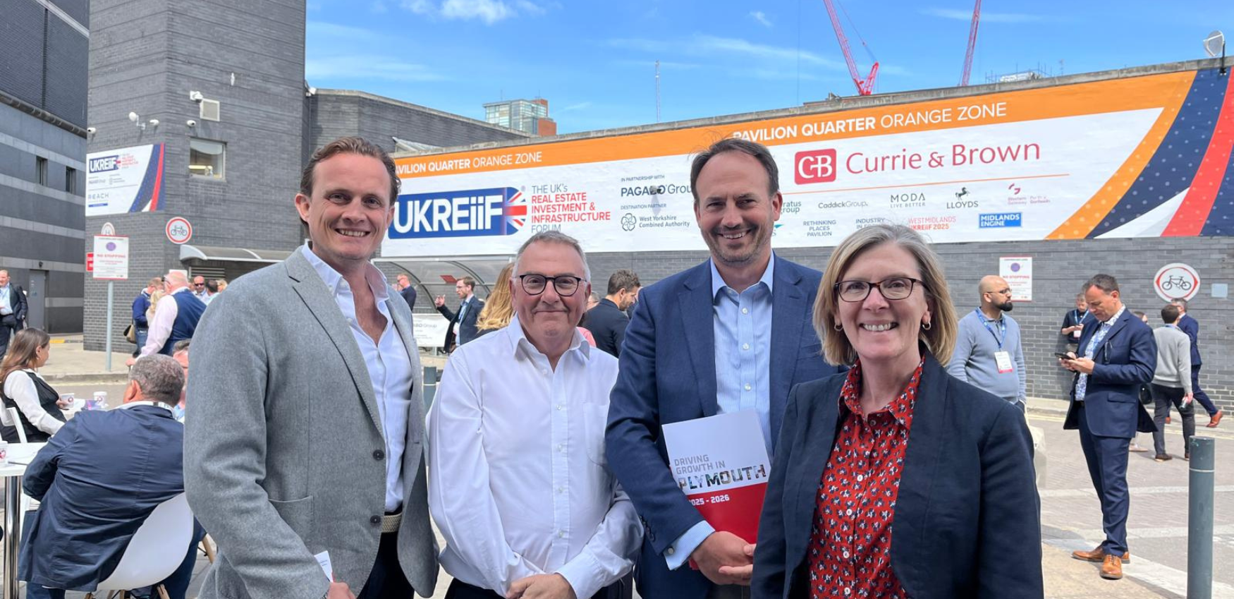 Four people stood in front of a UkReiif sign 