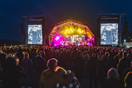 People watching music at a concert at night 