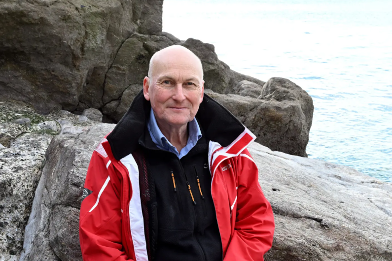 Richard Thompson sat on a rock 