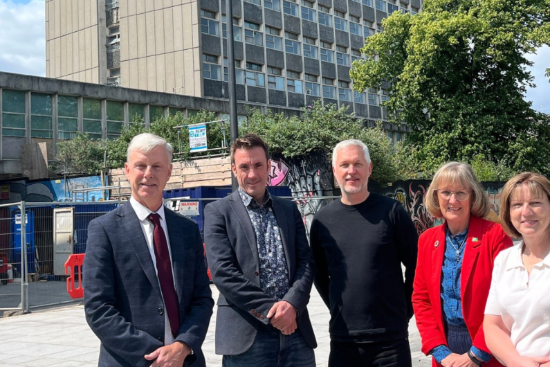 Four people stood in front of the Civic Centre