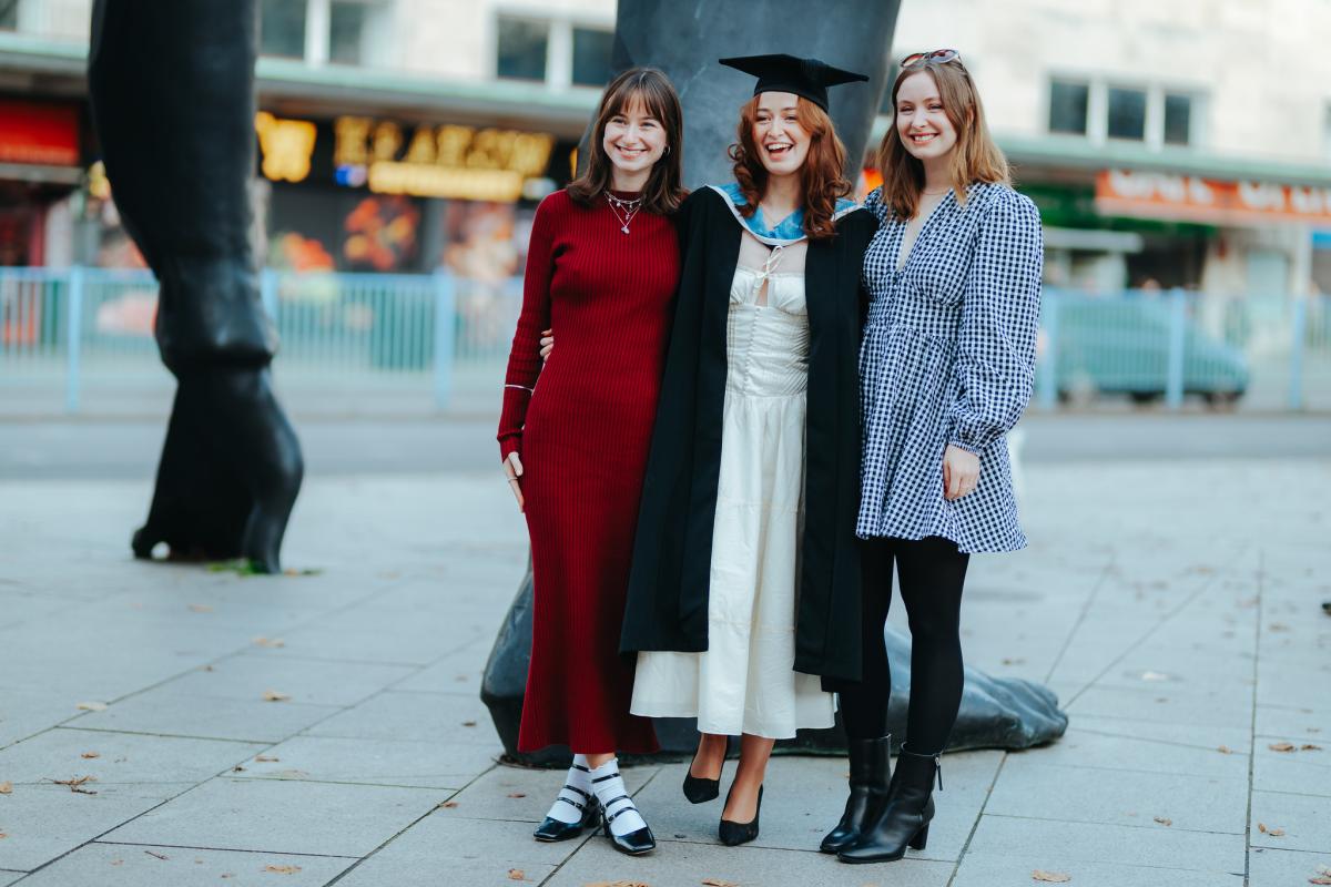 Three women standing outside trp after graduating